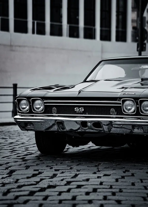 The front of a classic car in soft monochrome tones